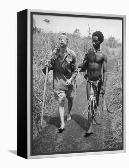 Papuan Native Helping a Wounded Australian Infantryman Along Road Away from the Buna Battlefront-George Silk-Framed Premier Image Canvas