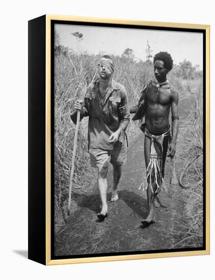 Papuan Native Helping a Wounded Australian Infantryman Along Road Away from the Buna Battlefront-George Silk-Framed Premier Image Canvas