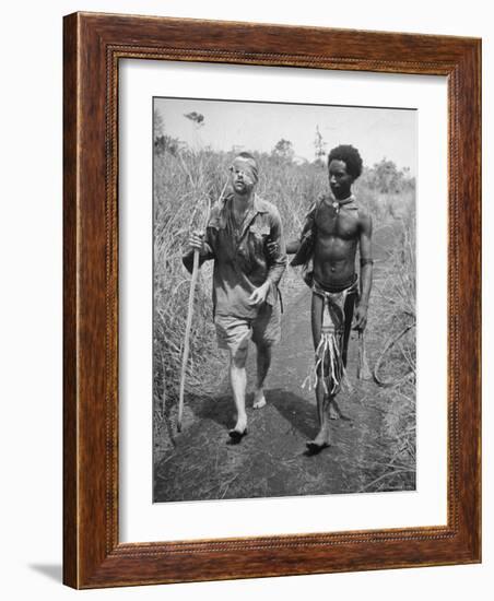 Papuan Native Helping a Wounded Australian Infantryman Along Road Away from the Buna Battlefront-George Silk-Framed Photographic Print