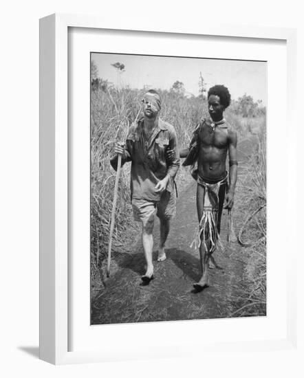 Papuan Native Helping a Wounded Australian Infantryman Along Road Away from the Buna Battlefront-George Silk-Framed Photographic Print