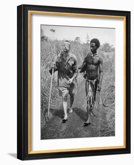 Papuan Native Helping a Wounded Australian Infantryman Along Road Away from the Buna Battlefront-George Silk-Framed Photographic Print