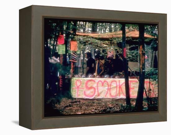 Paraphernalia Stand in Woods Featuring Pillows, Posters, and Incense, Woodstock Music and Art Fair-John Dominis-Framed Premier Image Canvas