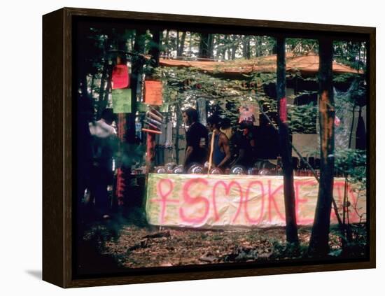 Paraphernalia Stand in Woods Featuring Pillows, Posters, and Incense, Woodstock Music and Art Fair-John Dominis-Framed Premier Image Canvas