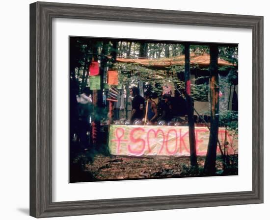Paraphernalia Stand in Woods Featuring Pillows, Posters, and Incense, Woodstock Music and Art Fair-John Dominis-Framed Photographic Print