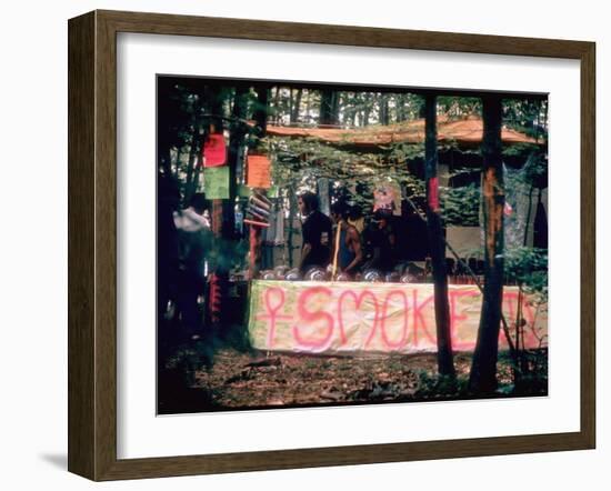 Paraphernalia Stand in Woods Featuring Pillows, Posters, and Incense, Woodstock Music and Art Fair-John Dominis-Framed Photographic Print