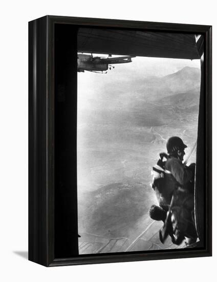 Paratrooper Making Way to Jump Off a Military Plane into Hostile Territories-John Dominis-Framed Premier Image Canvas