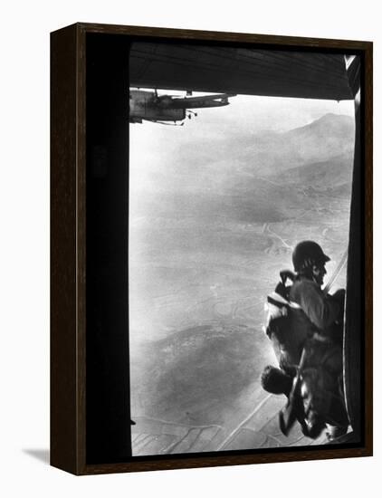 Paratrooper Making Way to Jump Off a Military Plane into Hostile Territories-John Dominis-Framed Premier Image Canvas