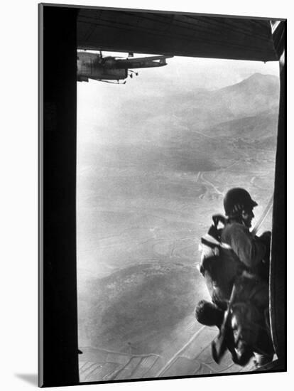 Paratrooper Making Way to Jump Off a Military Plane into Hostile Territories-John Dominis-Mounted Photographic Print