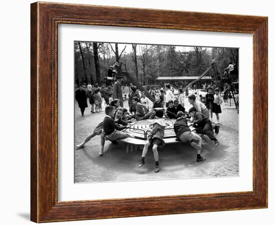 Parisian Children Riding Merry Go Round in a Playground-Alfred Eisenstaedt-Framed Photographic Print