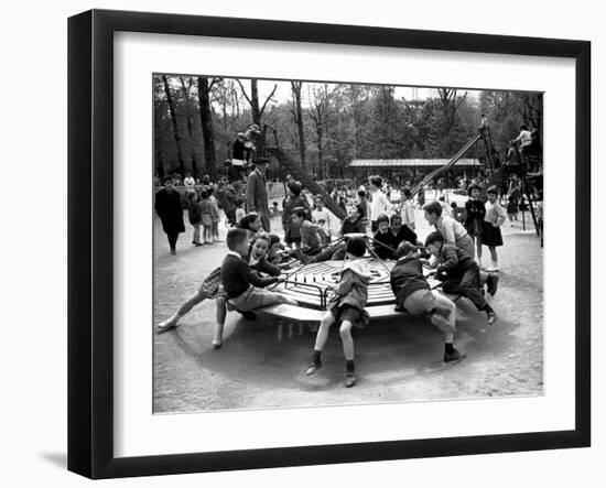 Parisian Children Riding Merry Go Round in a Playground-Alfred Eisenstaedt-Framed Photographic Print