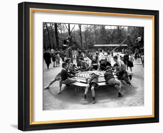 Parisian Children Riding Merry Go Round in a Playground-Alfred Eisenstaedt-Framed Photographic Print