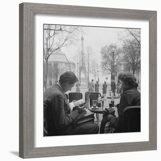 Parisian Couple Drinking Coca Cola at a Sidewalk Cafe While Reading, Paris, France, 1950-Mark Kauffman-Framed Photographic Print