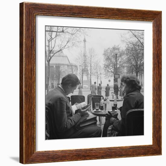 Parisian Couple Drinking Coca Cola at a Sidewalk Cafe While Reading, Paris, France, 1950-Mark Kauffman-Framed Photographic Print