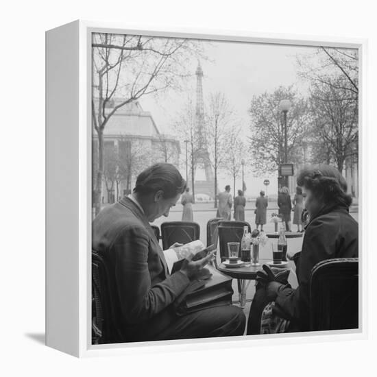 Parisian Couple Drinking Coca Cola at a Sidewalk Cafe While Reading, Paris, France, 1950-Mark Kauffman-Framed Premier Image Canvas