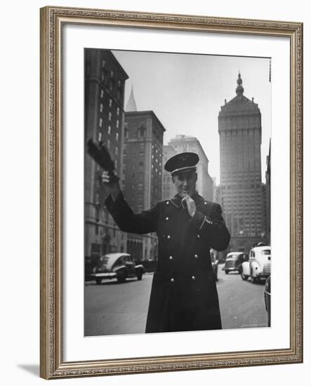 Park Avenue Doorman Using Whistle to Flag Down a Taxi For One of the Residents of His Building-William C^ Shrout-Framed Photographic Print