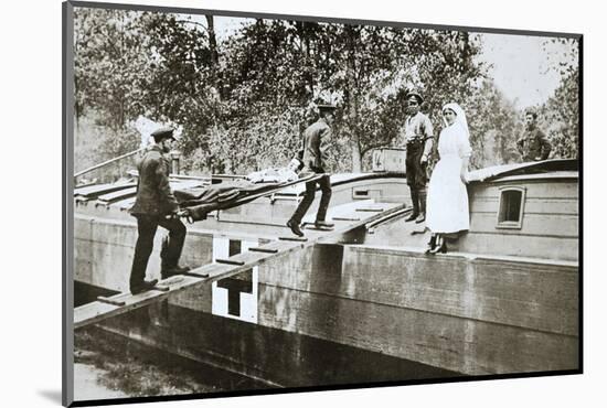 Patients being taken on board a hospital barge, Somme campaign, France, World War I, 1916-Unknown-Mounted Photographic Print