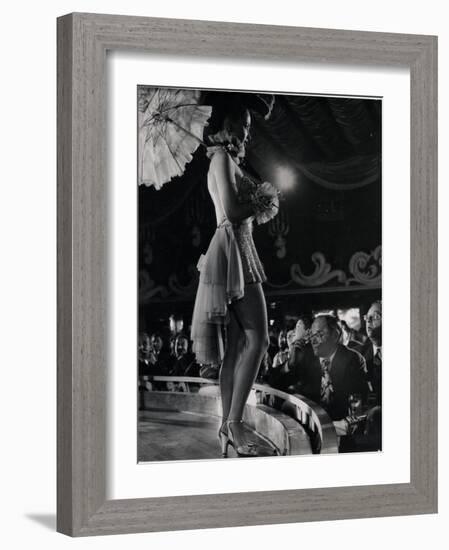 Patron at Stage-Side Table Looks Appraisingly at Tall Show Girl Standing at Edge of Stage-Gjon Mili-Framed Photographic Print