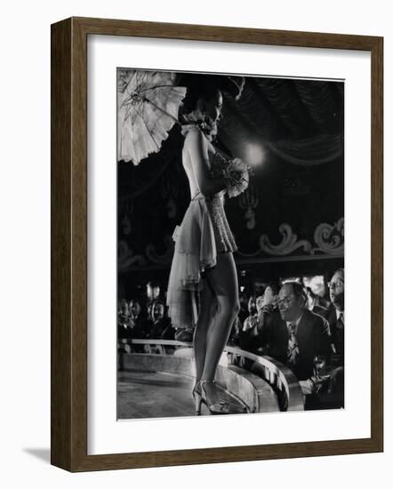 Patron at Stage-Side Table Looks Appraisingly at Tall Show Girl Standing at Edge of Stage-Gjon Mili-Framed Photographic Print