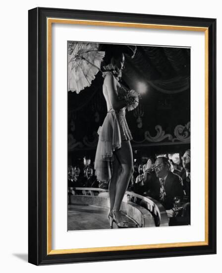 Patron at Stage-Side Table Looks Appraisingly at Tall Show Girl Standing at Edge of Stage-Gjon Mili-Framed Photographic Print