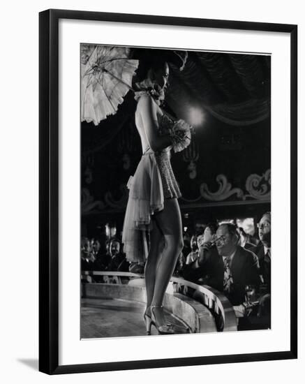 Patron at Stage-Side Table Looks Appraisingly at Tall Show Girl Standing at Edge of Stage-Gjon Mili-Framed Photographic Print