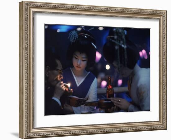 Patron of Nightclub Uruwashi Having His Cigarette Lit by Geisha-Eliot Elisofon-Framed Photographic Print