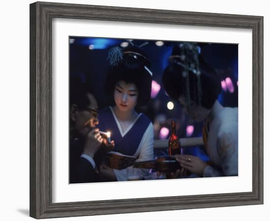 Patron of Nightclub Uruwashi Having His Cigarette Lit by Geisha-Eliot Elisofon-Framed Photographic Print