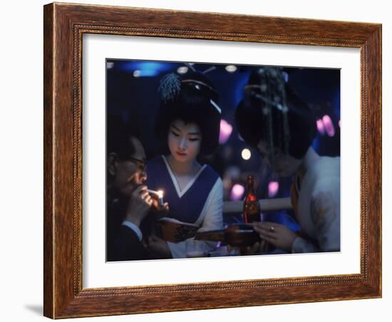 Patron of Nightclub Uruwashi Having His Cigarette Lit by Geisha-Eliot Elisofon-Framed Photographic Print