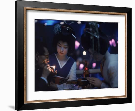 Patron of Nightclub Uruwashi Having His Cigarette Lit by Geisha-Eliot Elisofon-Framed Photographic Print