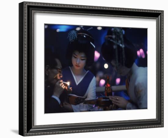 Patron of Nightclub Uruwashi Having His Cigarette Lit by Geisha-Eliot Elisofon-Framed Photographic Print