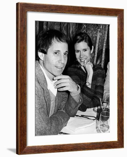 Paul Simon with Girlfriend, Carrie Fisher, at Party for Fisher's Dad, Singer Eddie Fisher-David Mcgough-Framed Premium Photographic Print