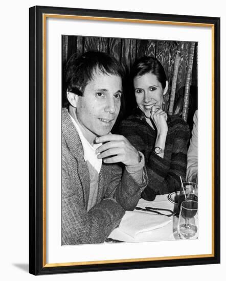 Paul Simon with Girlfriend, Carrie Fisher, at Party for Fisher's Dad, Singer Eddie Fisher-David Mcgough-Framed Premium Photographic Print