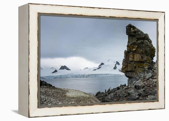 Penguins below dramatic rock formations, Half Moon Bay, South Sheltand Islands, Antarctica, Polar R-Michael Runkel-Framed Premier Image Canvas