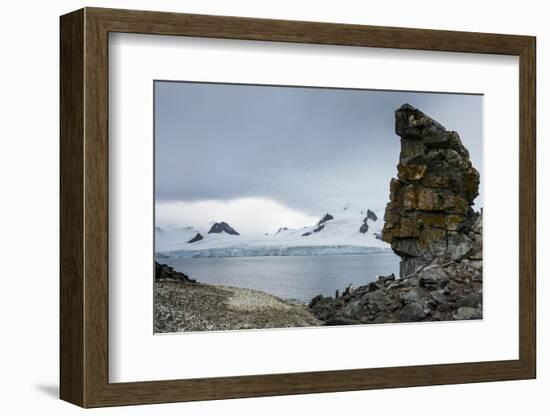 Penguins below dramatic rock formations, Half Moon Bay, South Sheltand Islands, Antarctica, Polar R-Michael Runkel-Framed Photographic Print