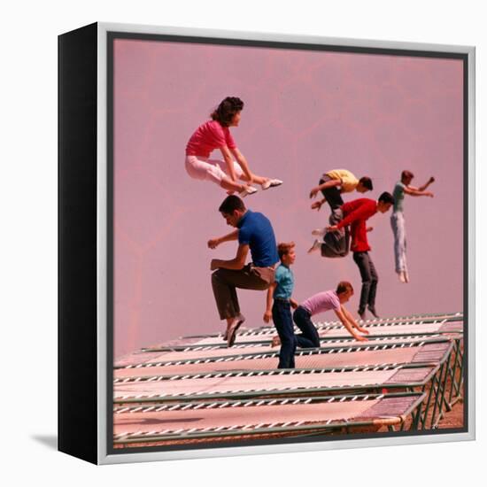 People Bouncing on Trampolines at Trampoline Center-J^ R^ Eyerman-Framed Premier Image Canvas