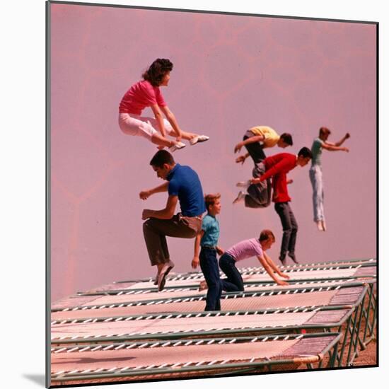 People Bouncing on Trampolines at Trampoline Center-J^ R^ Eyerman-Mounted Photographic Print