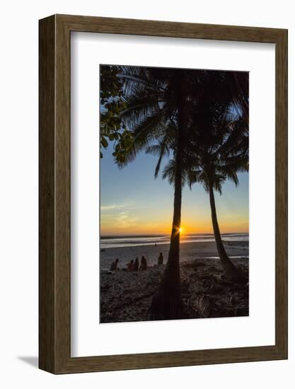 People by Palm Trees at Sunset on Playa Hermosa Beach, Santa Teresa, Costa Rica-Rob Francis-Framed Photographic Print