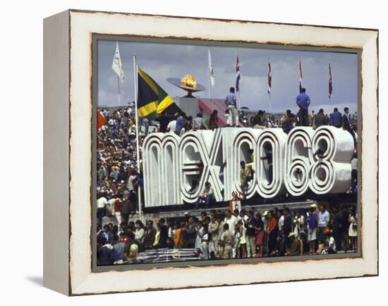 People Climbing and Sitting on a Mexico '68 Sign at the Summer Olympics-John Dominis-Framed Premier Image Canvas