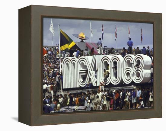 People Climbing and Sitting on a Mexico '68 Sign at the Summer Olympics-John Dominis-Framed Premier Image Canvas