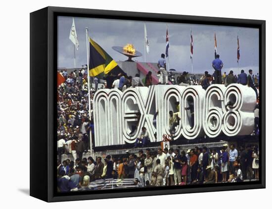 People Climbing and Sitting on a Mexico '68 Sign at the Summer Olympics-John Dominis-Framed Premier Image Canvas