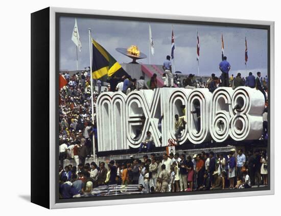 People Climbing and Sitting on a Mexico '68 Sign at the Summer Olympics-John Dominis-Framed Premier Image Canvas