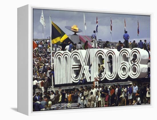 People Climbing and Sitting on a Mexico '68 Sign at the Summer Olympics-John Dominis-Framed Premier Image Canvas