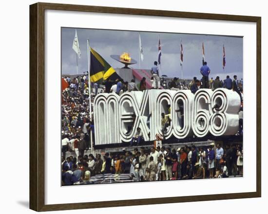 People Climbing and Sitting on a Mexico '68 Sign at the Summer Olympics-John Dominis-Framed Photographic Print