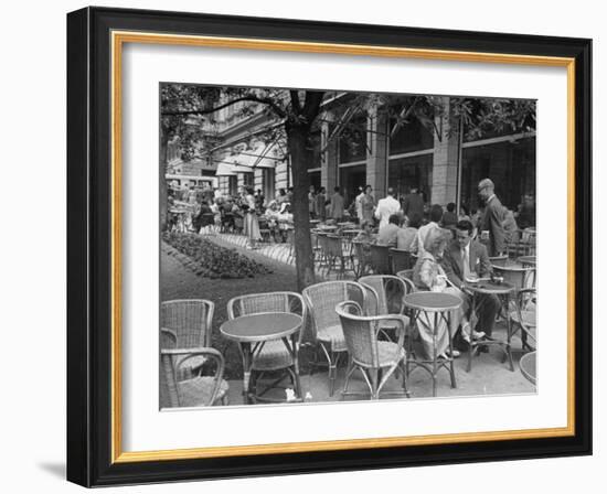 People Eating at a Sidewalk Cafe Next to the Excelsior Hotel-Dmitri Kessel-Framed Photographic Print