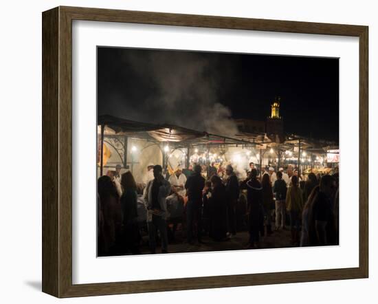 People eating at one of the stalls in Jemaa el-Fna at night, Marrakesh, Morocco-null-Framed Photographic Print