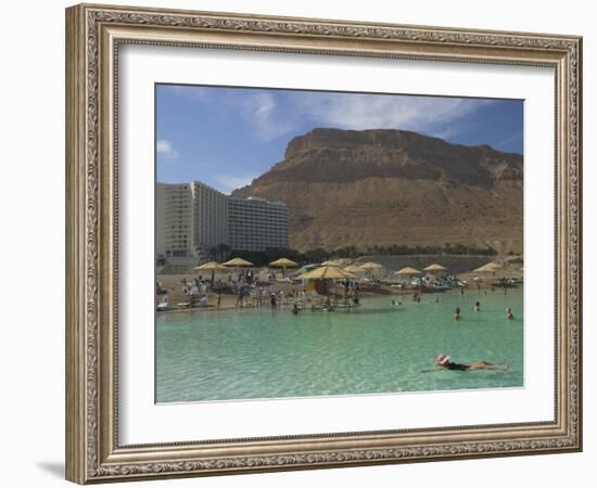 People Floating in the Sea and Hyatt Hotel and Desert Cliffs in Background, Dead Sea, Middle East-Eitan Simanor-Framed Photographic Print