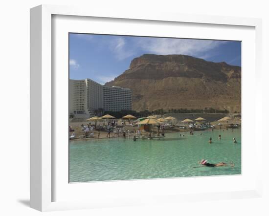 People Floating in the Sea and Hyatt Hotel and Desert Cliffs in Background, Dead Sea, Middle East-Eitan Simanor-Framed Photographic Print