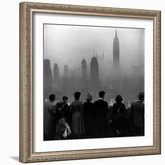 People on Top of a Building Looking Down Into Downtown Misty Smog covering Empire state Building-Eliot Elisofon-Framed Photographic Print