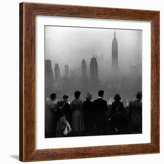 People on Top of a Building Looking Down Into Downtown Misty Smog covering Empire state Building-Eliot Elisofon-Framed Photographic Print