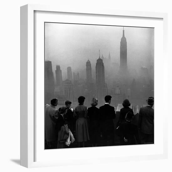 People on Top of a Building Looking Down Into Downtown Misty Smog covering Empire state Building-Eliot Elisofon-Framed Photographic Print