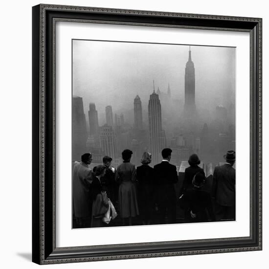 People on Top of a Building Looking Down Into Downtown Misty Smog covering Empire state Building-Eliot Elisofon-Framed Photographic Print